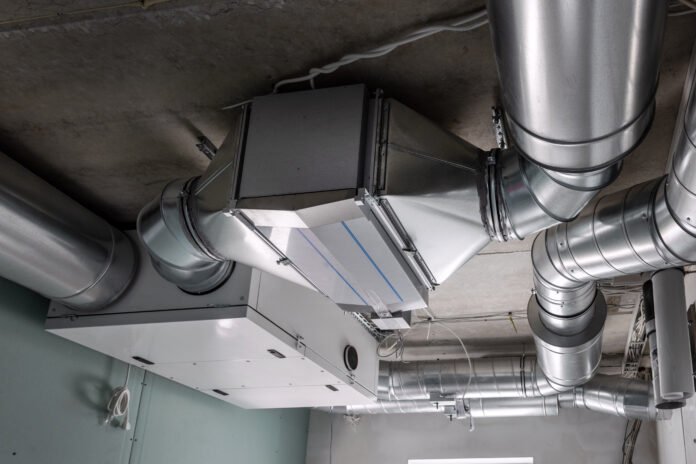 A ducted heat recovery ventilation system with recuperation. The system is shown with insulated metal ducts, a heat recovery core, and a recuperation unit. The unit is installed in a utility room.