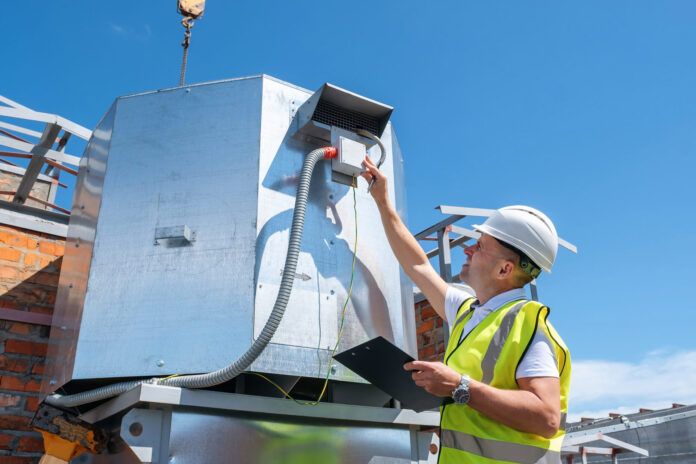 HVAC expert inspecting rooftop HVAC system.