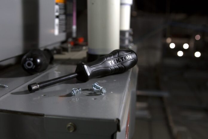 Image of a technician performing annual maintenance on an HVAC system.